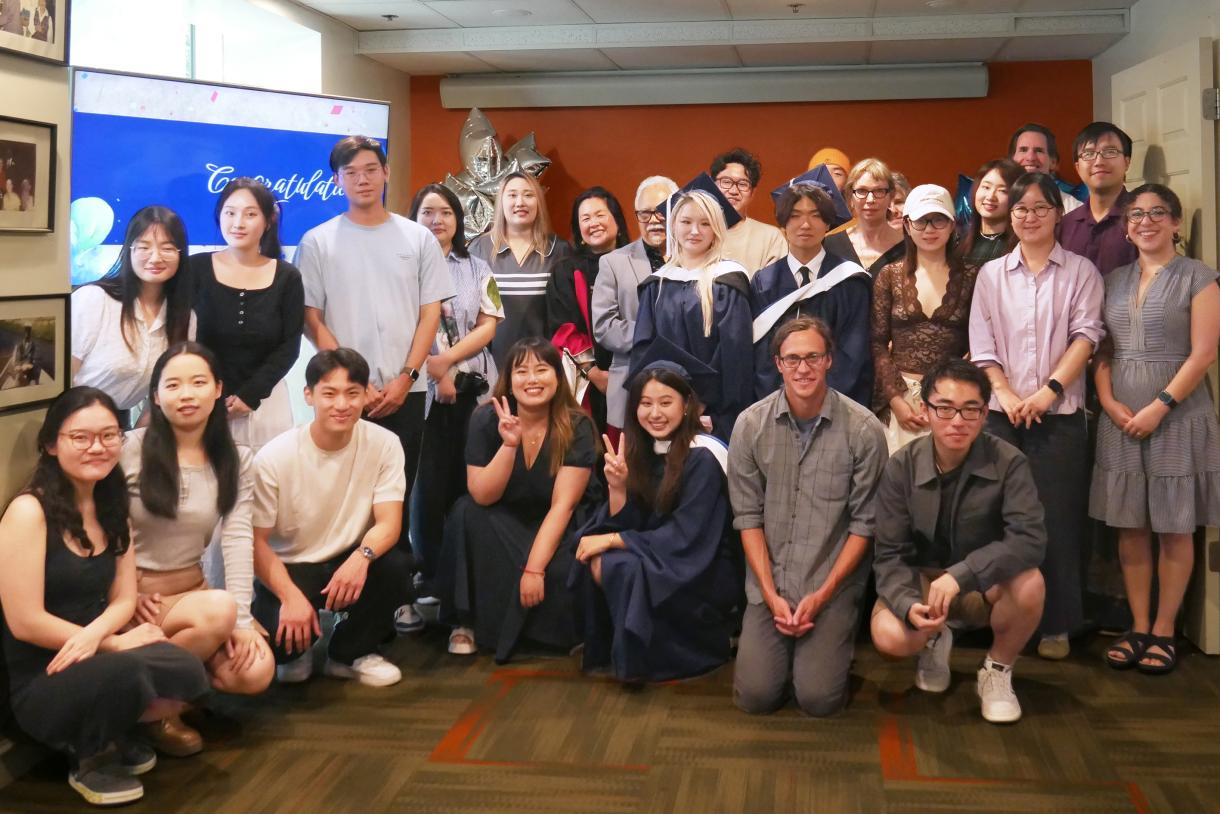 A group of people gathered for a photograph in a meeting room