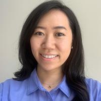 A person with long hair wearing a purple shirt